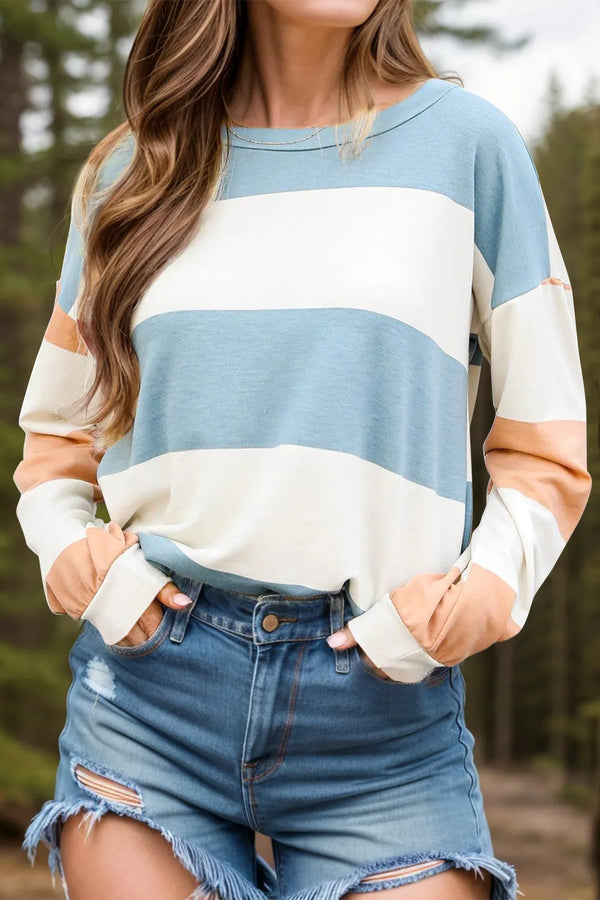Person wearing striped sweater with denim shorts